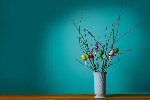 Easter composition. Front view of a white vase with a branch Stock Photos