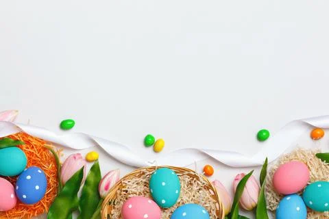 Easter composition on a gray background. Egg basket tulips. Stock Photos