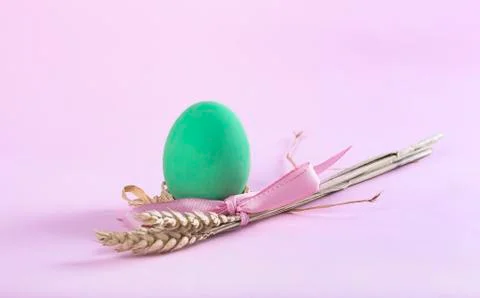 Easter composition with green painted egg and sheaf of wheat Stock Photos