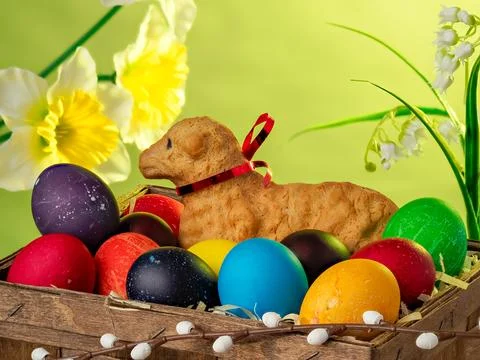 Easter composition, lamb made of bread, eggs painted in different colors Stock Photos