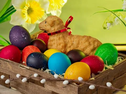 Easter composition, lamb made of bread, eggs painted in different colors Stock Photos