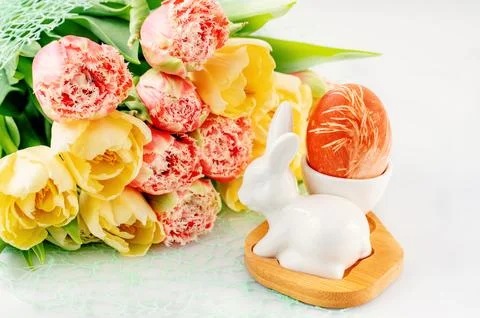 Easter composition on a light background. Cute white rabbits, yellow and pink Stock Photos