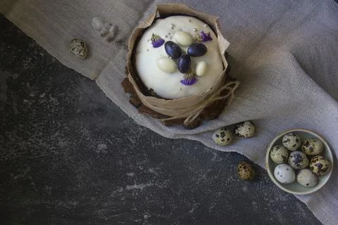 Easter composition on a linen napkin. Ester cake and quail eggs . Stock Photos