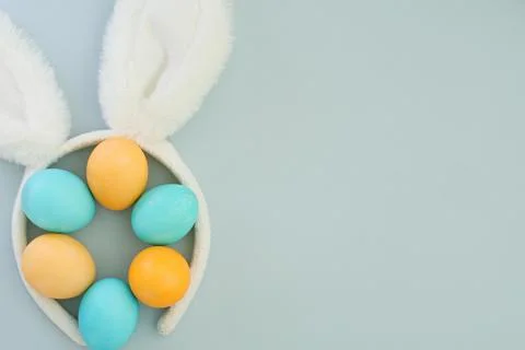 Easter composition in minimalist style with Easter pastel eggs and bunny ears on Stock Photos