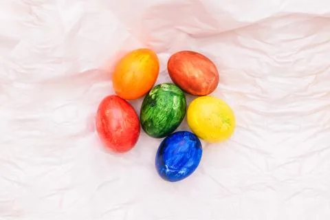 Easter composition with natural eggs on a white background. On crumpled paper Stock Photos