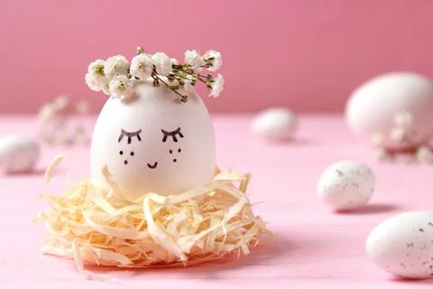 Easter composition of painted eggs and feathers on a colored background. Stock Photos