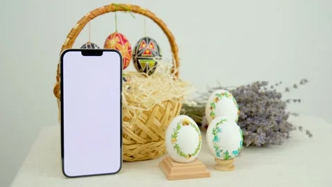 Easter composition with phone with white chroma key screen for advertising Stock Footage 235323840