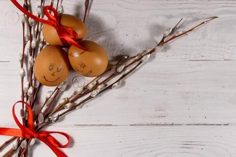 Easter composition with pussy willow twigs and eggs on white wooden table Stock Photos