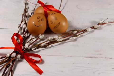Easter composition with pussy willow twigs and eggs on white wooden table Stock Photos