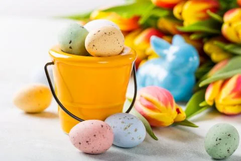 Easter composition with quail eggs and tulips Stock Photos