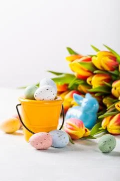 Easter composition with quail eggs and tulips Stock Photos