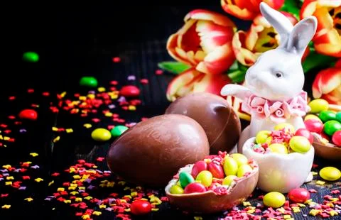 Easter composition with a rabbit and flowers, dark background, selective focu Stock Photos