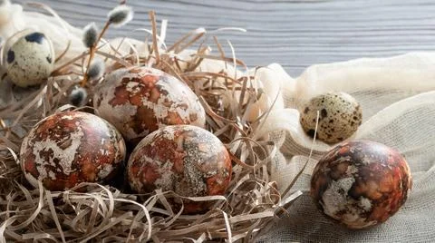 Easter composition - several marble eggs painted with natural dyes in a paper Stock Photos