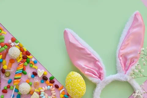 Easter composition with sweets and bunny ears space for text. Top view, flat Stock Photos
