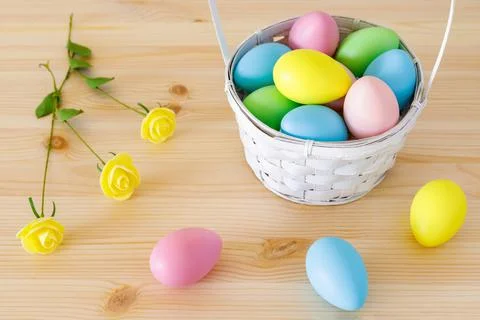 Easter composition on the table. Easter eggs in basket. Stock Photos