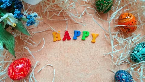 Easter composition, top view: phrase Happy Easter, Easter eggs, bouquet &amp; straw Stock Footage 103851396