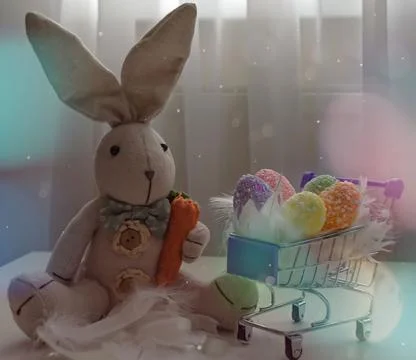 Easter composition toy bunny with colored eggs in a grocery cart Stock Photos