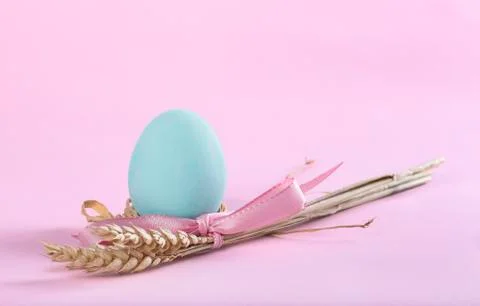 Easter composition with turquoise painted egg and sheaf of wheat Stock Photos