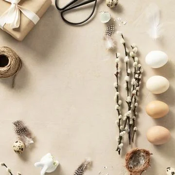 Easter composition with vintage Easter decorations on beige stone background Stock Photos