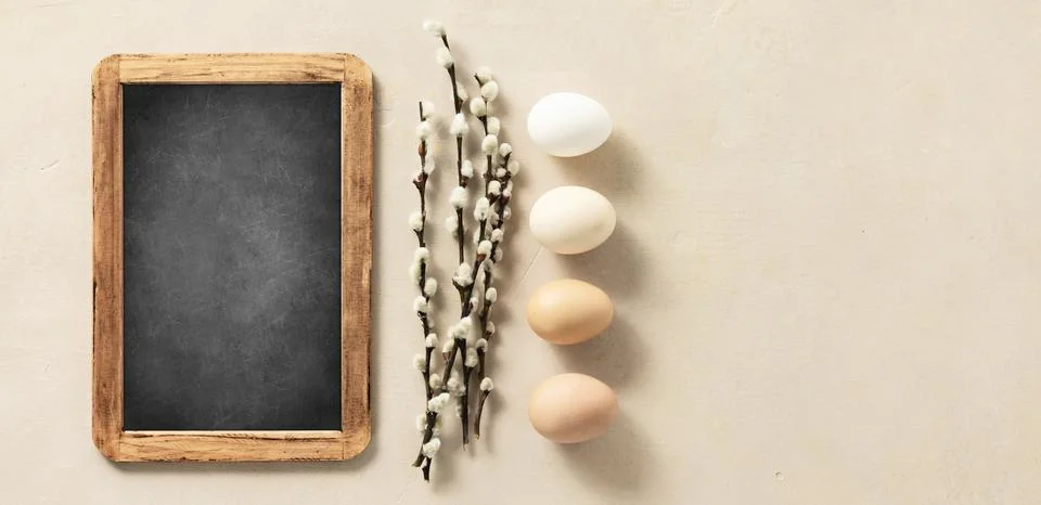 Easter composition with vintage Easter decorations and chalk board on beige.. Stock Photos