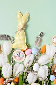 Easter Composition with White Tulips, Decorative Eggs, Carrots, and Feathers on Stock Photos