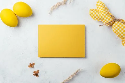 Easter composition of yellow blank postcard on white background and handmad.. Stock Photos