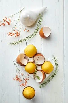 Easter composition with yellow eggs and flowers. Natural dyed colorful eggs a Stock Photos