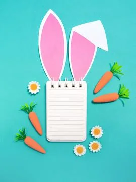 Easter composition.Notepad with place for text with rabbit ears Stock Photos
