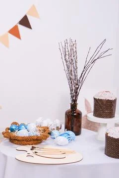 Easter compositions with blue painted eggs and traditional cakes on table. Stock Photos