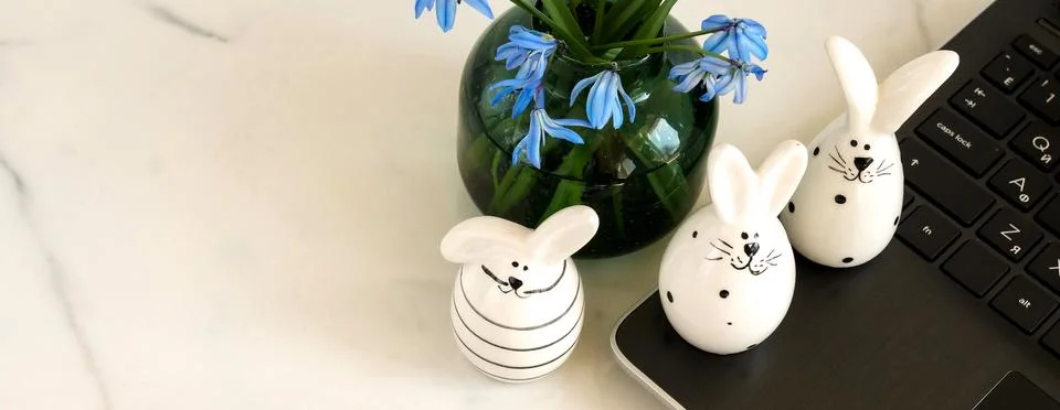 Easter concept banner. Flat lay office table, workspace with laptop, Easter bunn Stock Photos