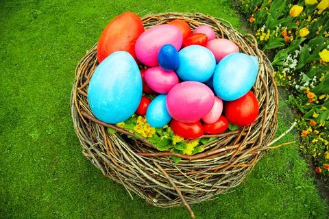 Easter concept. basket with Easter eggs on the grass. against the backdrop of Stock Photos