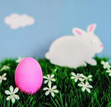 An Easter concept depicting a pink colored Egg and bunny  Stock Photos