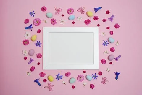 Easter concept. Easter eggs, flowers, photo frame and buds Stock Photos