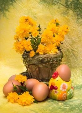 Easter concept. eggs and spring flowers with a figure of a chicken Stock Photos