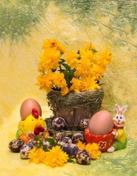 Easter concept.  eggs and spring flowers with a figure of chicken and rabbit Stock Photos