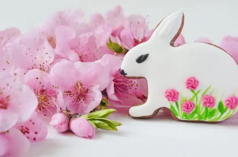 Easter concept. gingerbread bunny surrounded by spring flowers Stock Photos