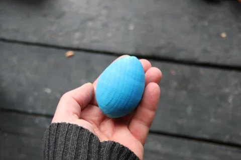 Easter concept. Hand holding an egg Stock Photos