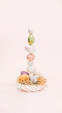 Easter concept made of pastel eggs, wicker wooden wreath and bright decor Stock Photos