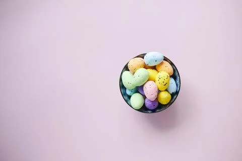 Easter concept with multi color egg on pink background. Stock Photos