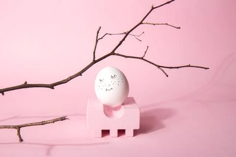 Easter concept. Pink geometric shape podium and easter smiling egg with golde Stock Photos