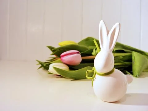 Easter concept, spring tulips and porcelain bunny Stock Photos