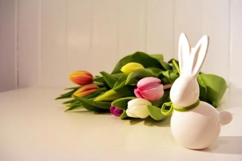 Easter concept, spring tulips and porcelain bunny Stock Photos