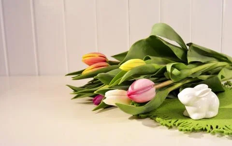 Easter concept, spring tulips and porcelain bunny Stock Photos