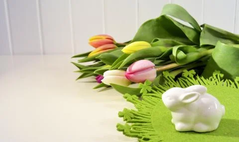 Easter concept, spring tulips and porcelain bunny Stock Photos