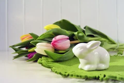 Easter concept, spring tulips and porcelain bunny Stock Photos