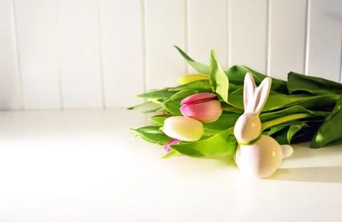 Easter concept, spring tulips and porcelain bunny Stock Photos