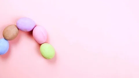 Easter concept stop motion . Colorful egg make wave, pink background, top view Vídeo Stock 126720634