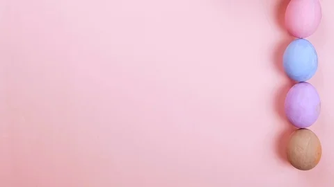 Easter concept stop motion. Egg appear, put in basket, pink background, top view Vídeo Stock 126720463