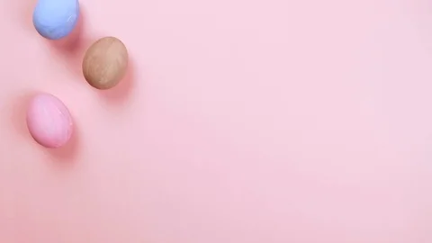 Easter concept stop motion. Egg appear on pink background, copyspace, top view Stock Footage