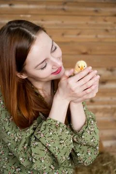 Easter concept. Vertical portrait of Young red head girl holding cute little  Stock Photos